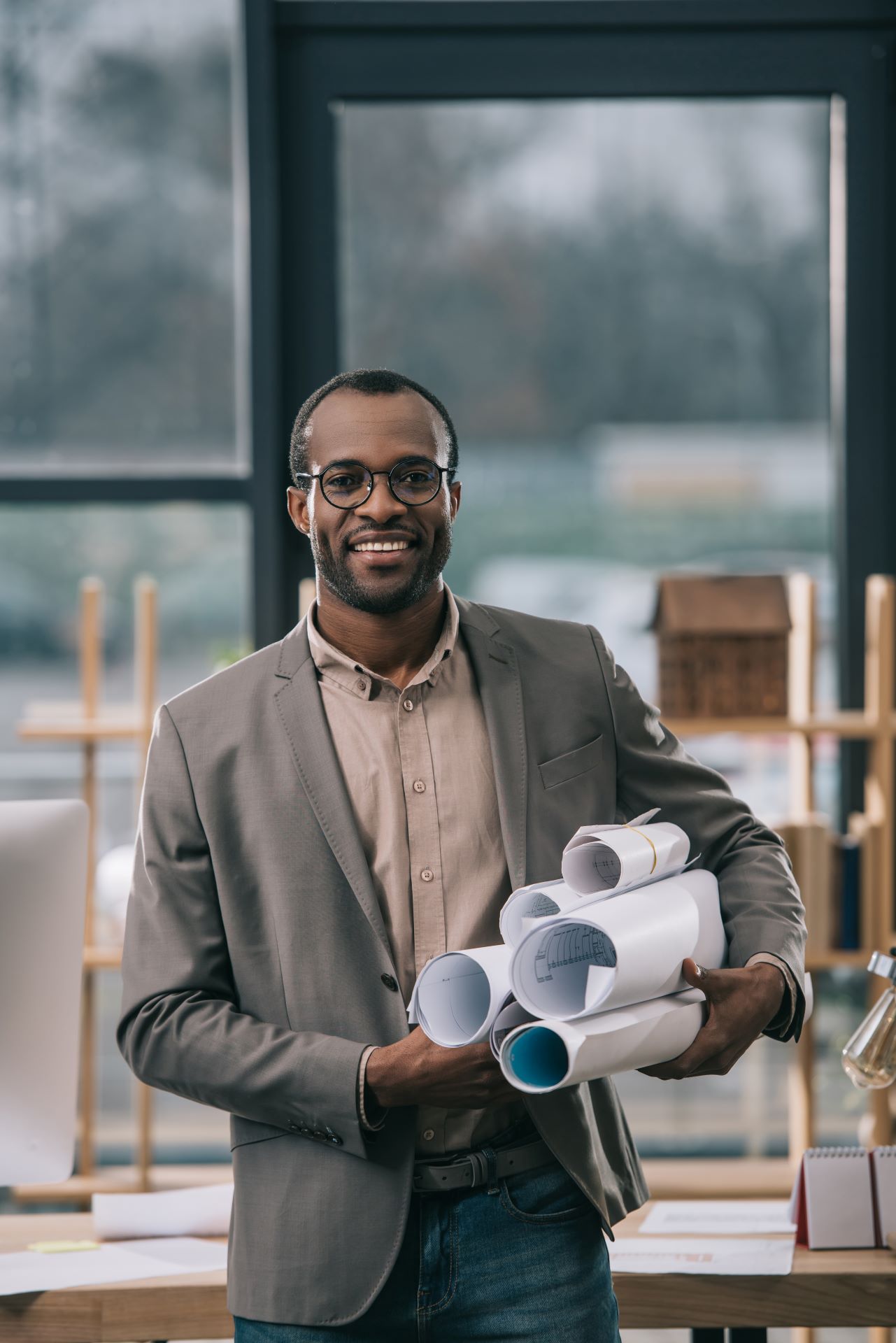cheerful-african-american-architect-holding-bluepr-2024-11-17-17-04-27-utc.jpg