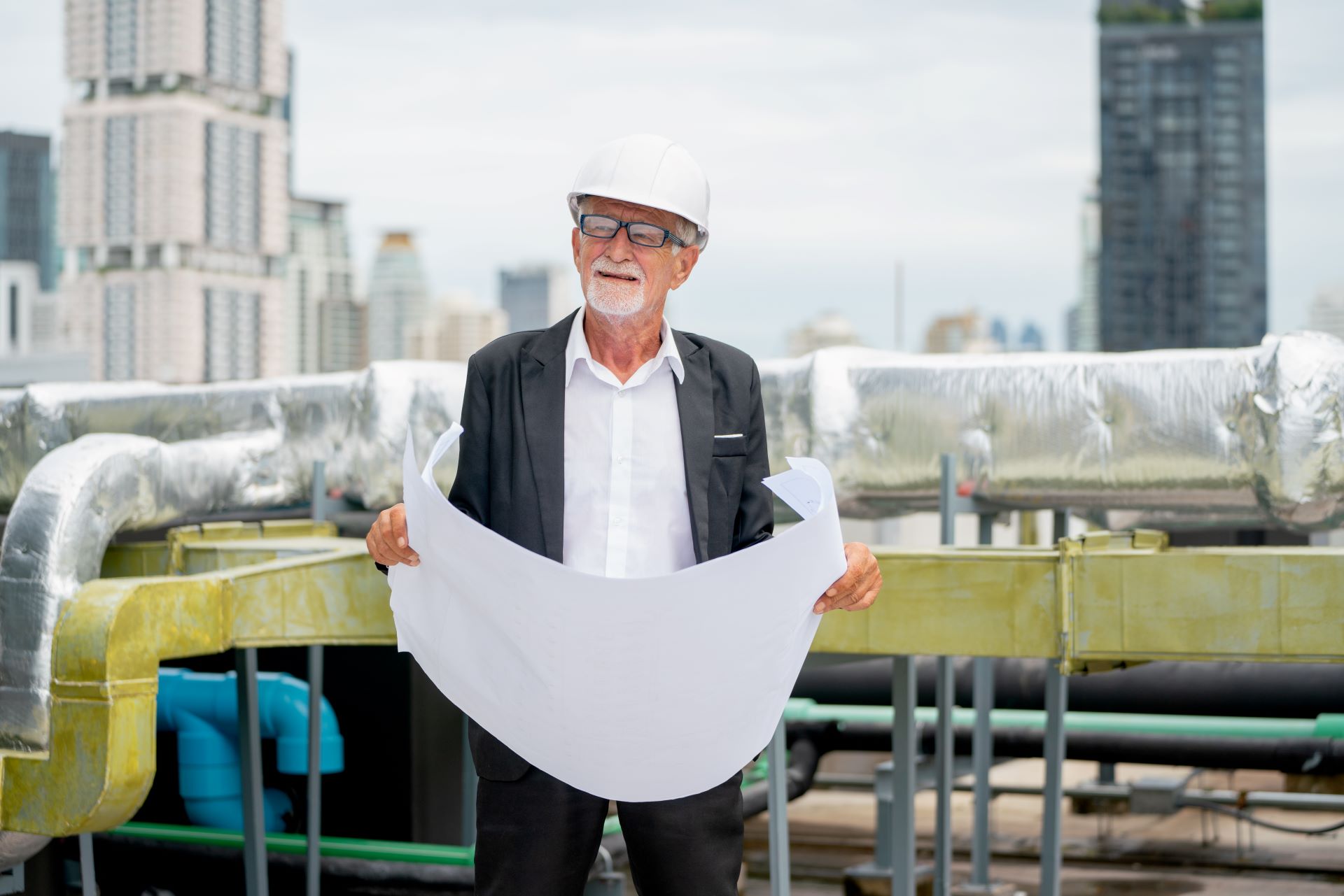 senior-engineer-man-hold-drawing-of-building-and-2025-03-09-01-02-42-utc.jpg